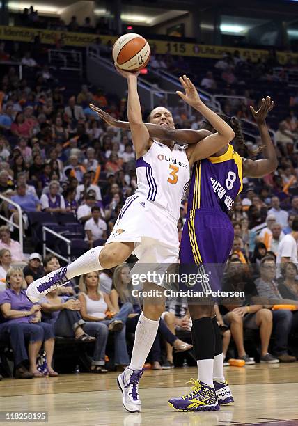 Diana Taurasi of the Phoenix Mercury is fouled by DeLisha Milton-Jones of the Los Angeles Sparks as she attempts a shot during the WNBA game at US...