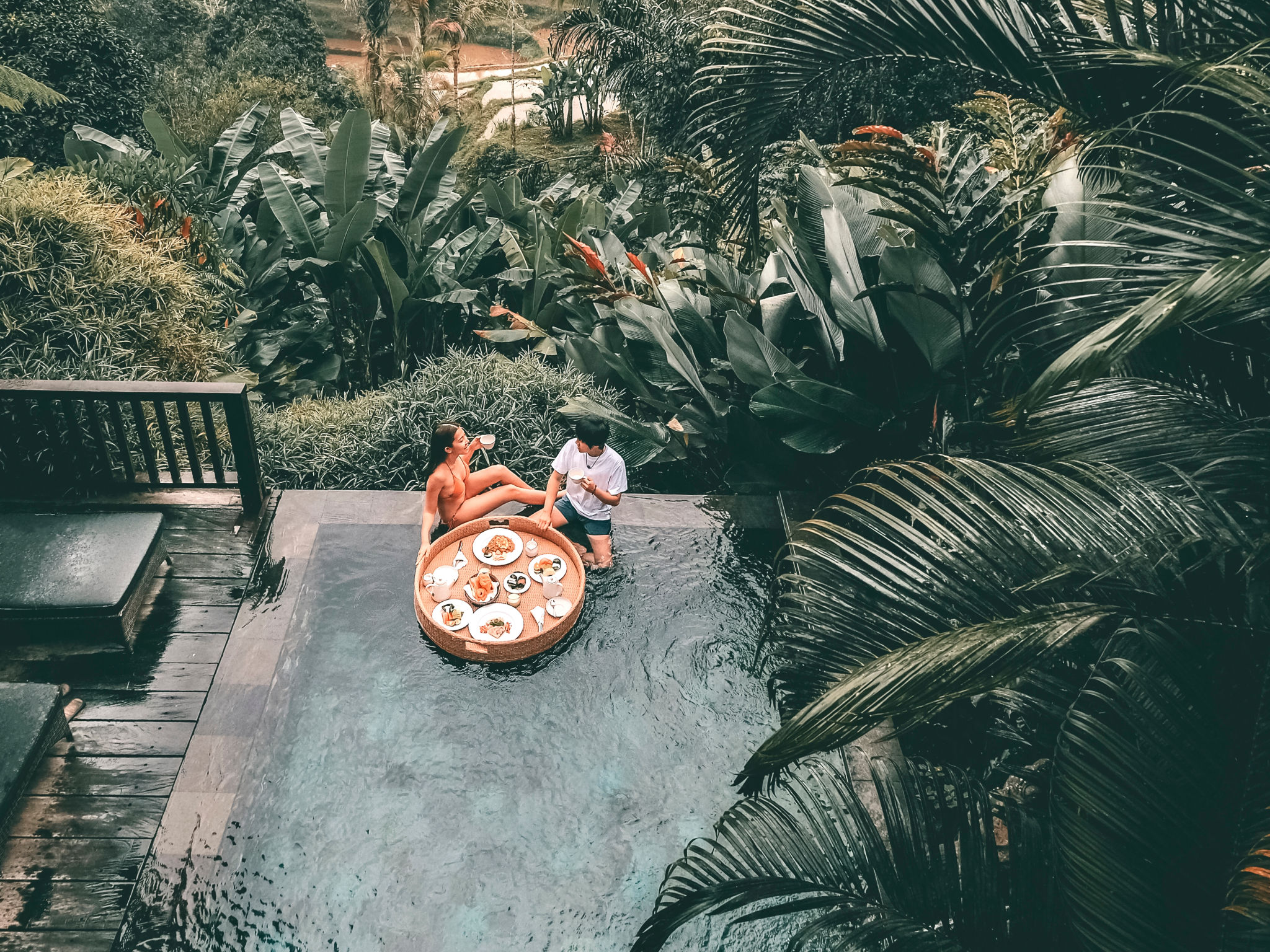Floating breakfast in infinity pool on paradise swimming pool, morning in the tropical resort Bali, Indonesia Floating breakfast in infinity pool on paradise swimming pool, morning in the tropical resort Bali, Indonesia