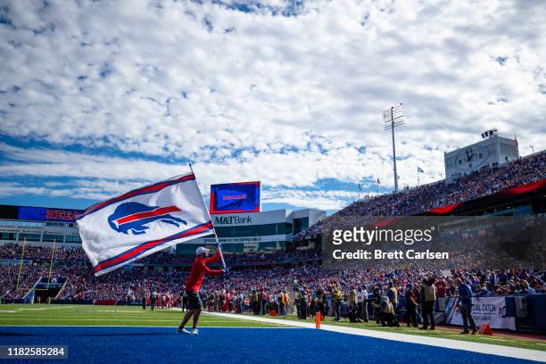 Buffalo Bills staff member waves a flag with the team"u2019s logo during the second quarter against the Miami Dolphins at New Era Field on October...