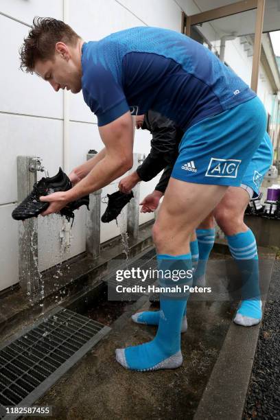 Jordie Barrett of the All Blacks cleans his boots following a New Zealand All Blacks training session at Tatsuminomori Seaside Park on October 22,...