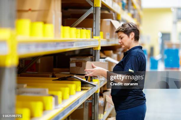 worker picking inventory in warehouse - warehouse worker stock pictures, royalty-free photos & images