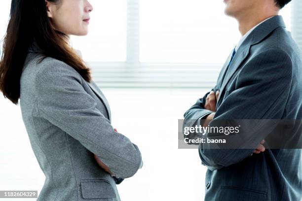 two businesspeople standing face to face - bossy worker stock pictures, royalty-free photos & images
