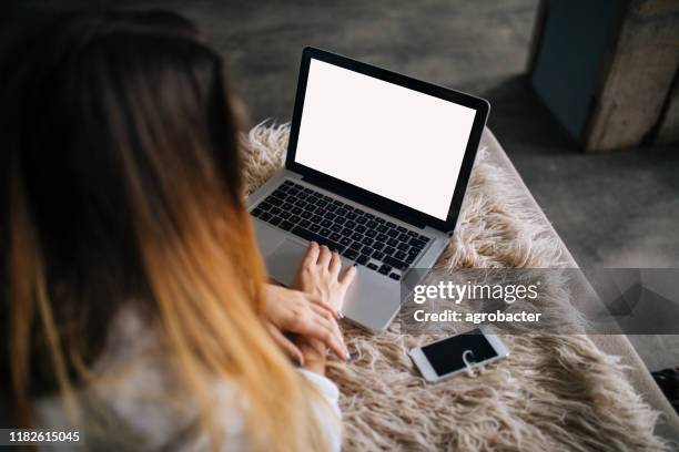 vrouw met blanco scherm laptop op bed - woman laptop screen stockfoto's en -beelden