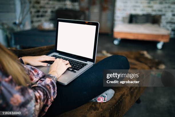 young woman using laptop with blank screen - computer screen over shoulder stock pictures, royalty-free photos & images