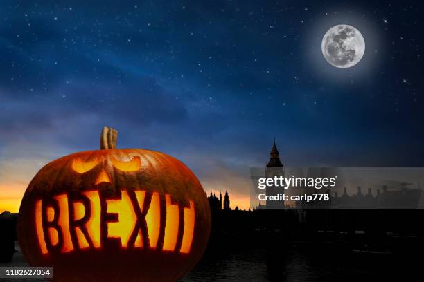 brexit pumpkin in night sky with houses of parliament - brexit food stock pictures, royalty-free photos & images