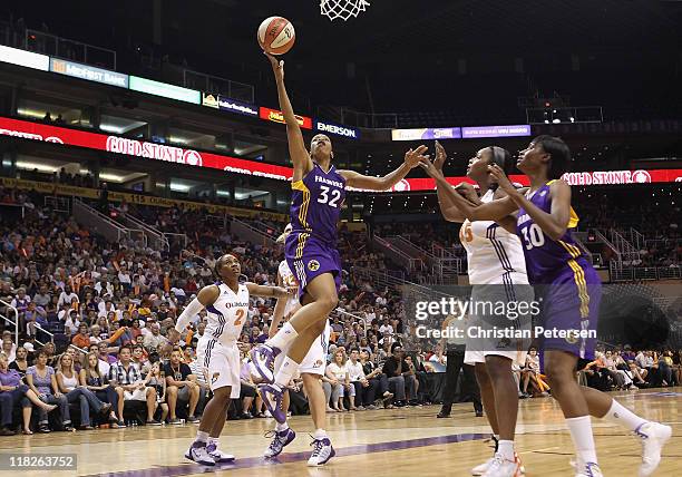 Tina Thompson of the Los Angeles Sparks lays up a shot against the Phoenix Mercury during the WNBA game at US Airways Center on July 5, 2011 in...