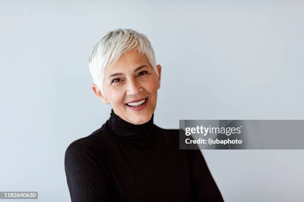 live your life and forget your age - older woman short hair stock pictures, royalty-free photos & images