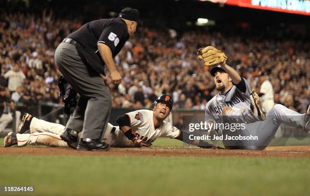 Chad Qualls of the San Diego Padres reacts after tagging out Andres Torres of the San Francisco Giants after trying to score on a fielders choice in...