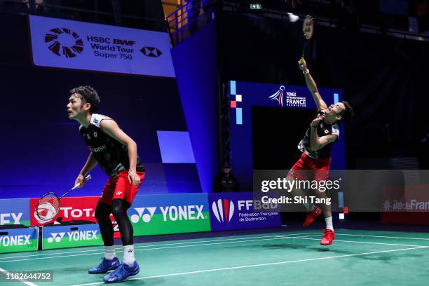 Takeshi Kamura and Keigo Sonoda of Japan compete in the Men's Doubles first round match against Goh V Shem and Tan Wee Kiong of Malaysia on day one...