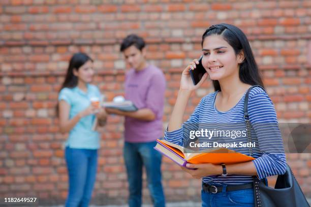 studente universitario sorridente con libri in mano - foto d'archivio - indian society and culture foto e immagini stock