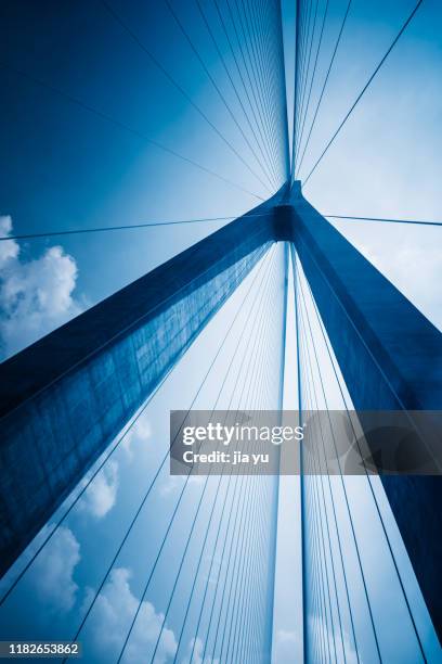 low angle view of cables against sky - suspension bridge stock pictures, royalty-free photos & images