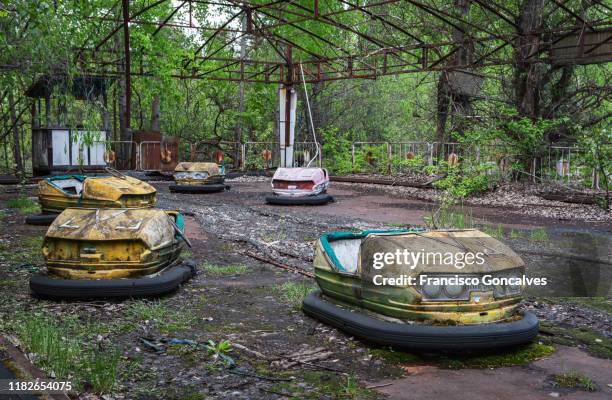 rusty bumper cars in the abandoned amusement park of pripyat ghost city - abandoned city stock-fotos und bilder