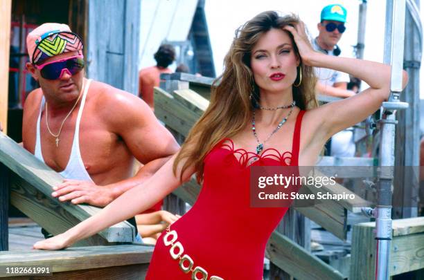 Portrait of American model and actress Carol Alt, in a red outfit, as she poses on the set of her television series, 'Thunder in Paradise,' Los...