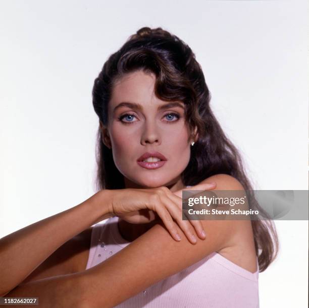 Portrait of American model and actress Carol Alt, in a pink tank top, as she poses against a white background, Los Angeles, California, 1993.