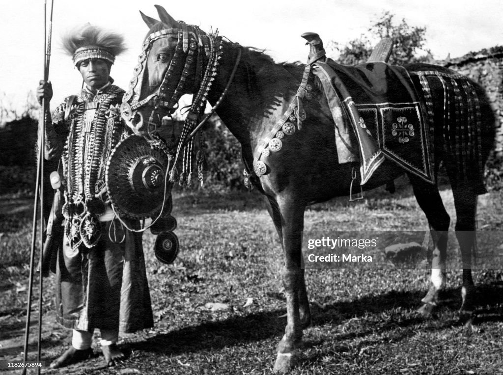 Africa, ethiopia, seioano festively decorated warrior with his horse, 1920-30