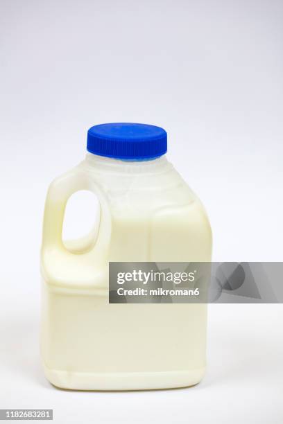 plastic bottle full of milk - milk bottle stock-fotos und bilder