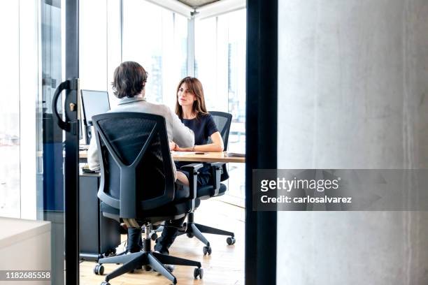 woman interviewing a man for a job - hiring manager stock pictures, royalty-free photos & images