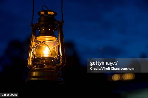 oil lamp lighting up the darkness or burning kerosene lamp background, camping  light concept - kérosène photos et images de collection