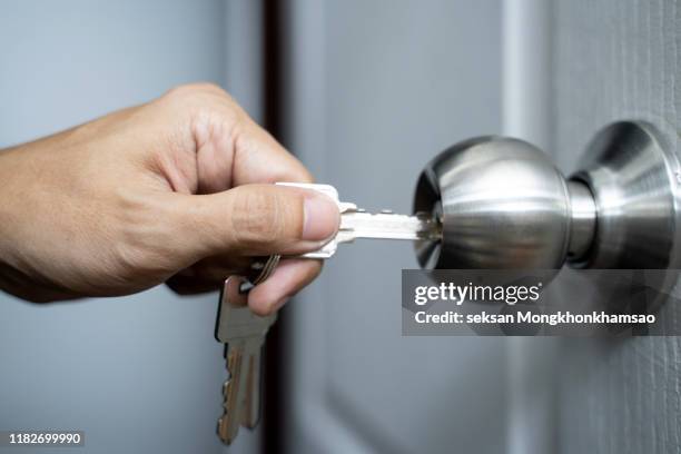 unlocking door with a key. - locking stockfoto's en -beelden