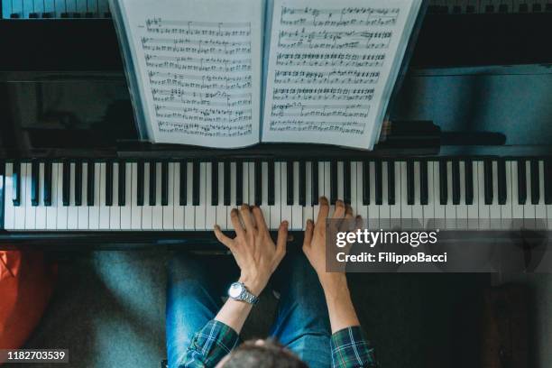 high angle view of a pianist playing piano - music sheet stock pictures, royalty-free photos & images