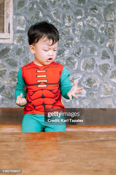 a male toddler is wearing a halloween costume - baby being held stockfoto's en -beelden