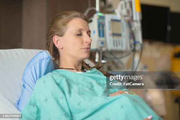 a pregnant mom pausing to breathe during labor in the hospital stock photo - showus doctor stock pictures, royalty-free photos & images