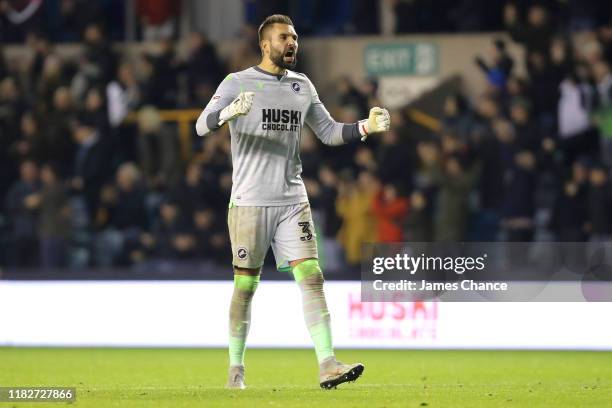 Bartosz Bialkowski of Millwall celebrates his sides first goal during the Sky Bet Championship match between Millwall FC and Cardiff City at The Den...