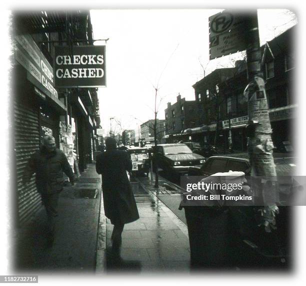 December 6: MANDATORY CREDIT Bill Tompkins/Getty Images Store sign that reds CHECKS CASHED on December 6, 1990 in New York City.