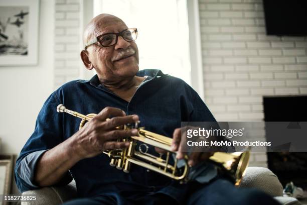 portrait of senior man with trumpet - musician stock pictures, royalty-free photos & images