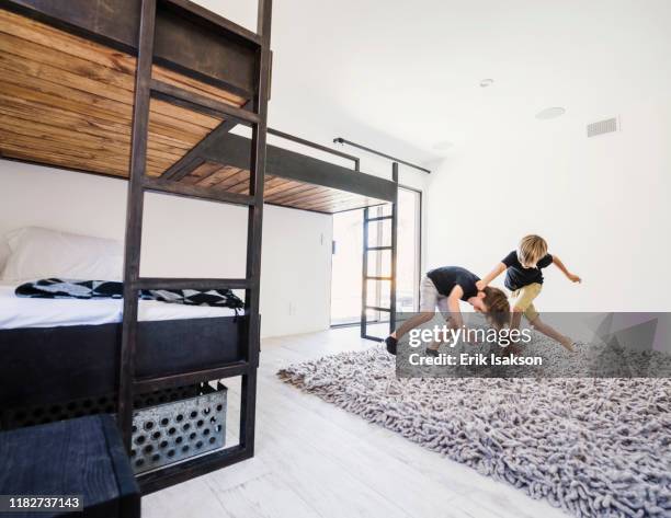 boys play fighting by bunk beds - play fight stock pictures, royalty-free photos & images