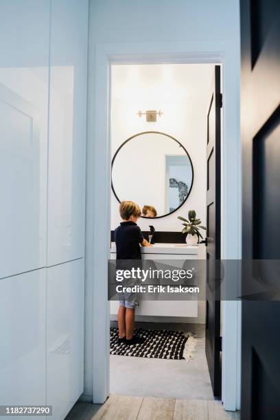 boy washing his hands in bathroom - children circle floor stock pictures, royalty-free photos & images