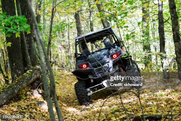 trail riding on 4x4 side-by-side off-road vehicle - side by side atv stock pictures, royalty-free photos & images