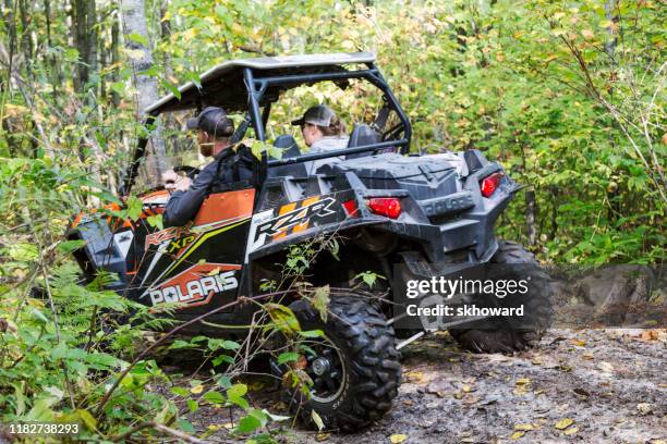 trail riding on 4x4 side-by-side off-road vehicle - side by side imagens e fotografias de stock