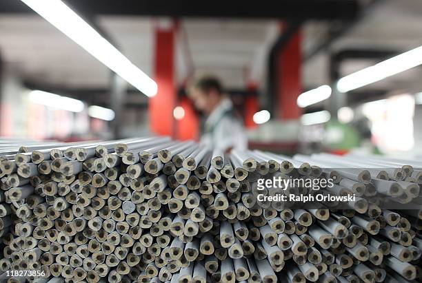 Graphite pencils lie on a production line at the manufacturing plant of the Faber-Castell factory on July 5, 2011 in Stein near Nuremberg, Germany....
