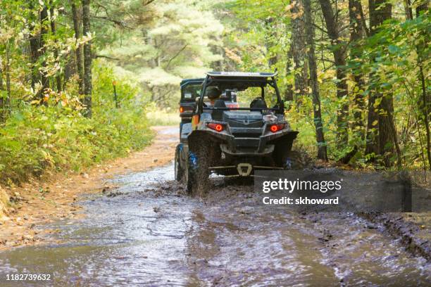 trail riding on 4x4 side-by-side off-road vehicles - side by side atv stock pictures, royalty-free photos & images