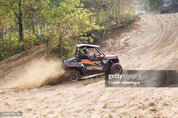 sand pit riding on 4x4 side-by-side off-road vehicles - side by side atv stock pictures, royalty-free photos & images