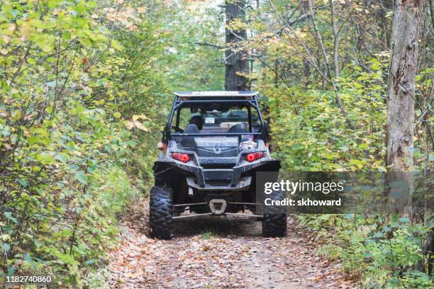 trail riding on 4x4 side-by-side off-road vehicles - side by side atv stock pictures, royalty-free photos & images