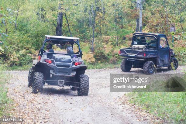 trail riding on 4x4 side-by-side off-road vehicles - side by side atv stock pictures, royalty-free photos & images