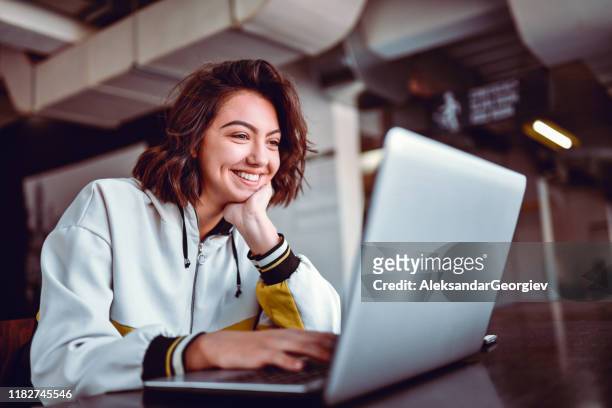 hispanic female studying on laptop - using laptop stock pictures, royalty-free photos & images