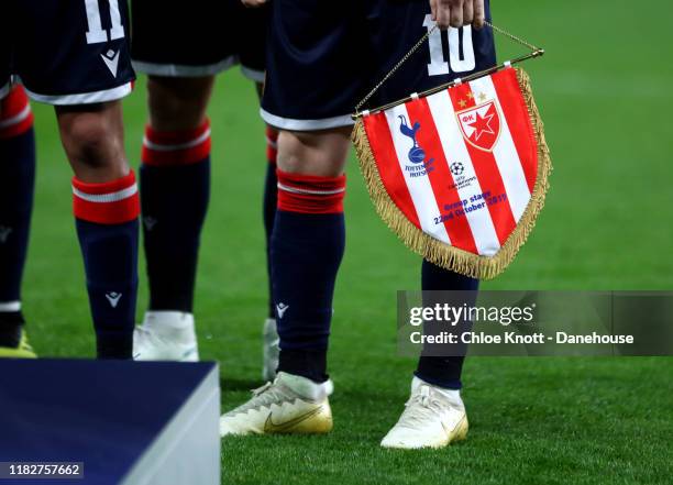 Marko Marin of Crvena Zvezda holds the Crvena Zvezda pennant ahead of the UEFA Champions League group B match between Tottenham Hotspur and Crvena...