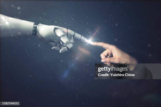 robot finger touching to human finger - robot human hand stock pictures, royalty-free photos & images