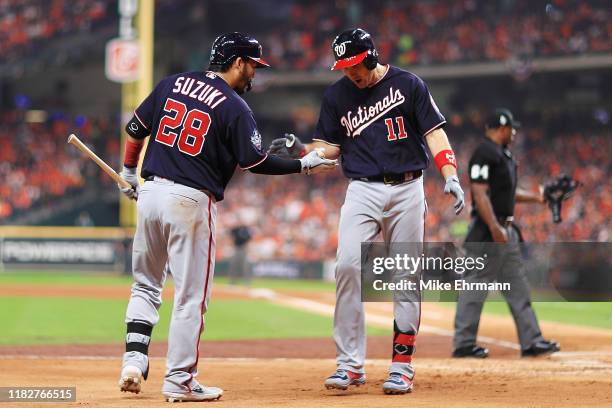 Ryan Zimmerman of the Washington Nationals is congratulated by his teammate Kurt Suzuki after hitting a solo home run against the Houston Astros...