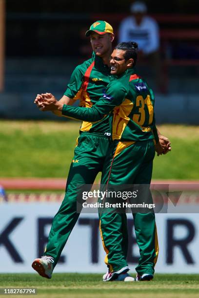 Beau Webster celebrates with Clive Rose of Tasmania after taking a catch to dismiss Matthew Gilkes of NSW during the Marsh One Day Cup match between...