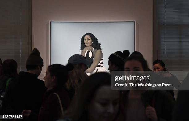 Crowds are often huddled around the portrait of first lady Michelle Obama at the National Portrait Gallery. -The installation of the portraits of...