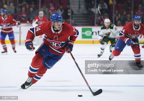 Nick Suzuki of the Montreal Canadiens skates with the puck against the Minnesota Wild in the NHL game at the Bell Centre on October 17, 2019 in...