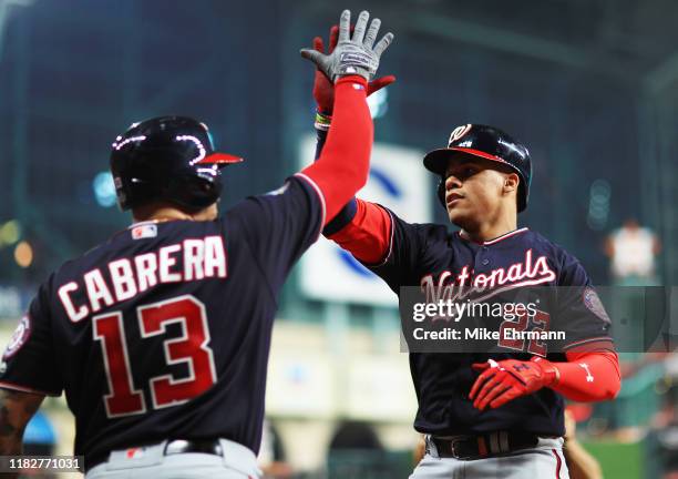 Juan Soto of the Washington Nationals is congratulated by his teammate Asdrubal Cabrera after hitting a solo home run against the Houston Astros...