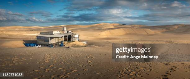 tin city in the sand dunes at sunrise - newcastle new south wales stock pictures, royalty-free photos & images