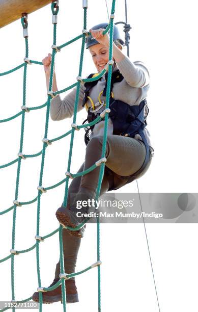 Sophie, Countess of Wessex wears a climbing harness and helmet as she tries out a high-wire assault course during The Countess of Wessex Cup 2019 at...