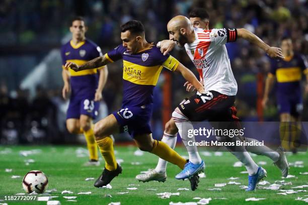 Carlos Tevez of Boca Juniors and Javier Pinola of River Plate fight for the ball during the Semifinal second leg match between Boca Juniors and River...