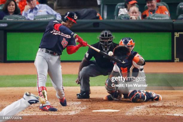 Juan Soto of the Washington Nationals hits a solo home run against the Houston Astros during the fourth inning in Game One of the 2019 World Series...